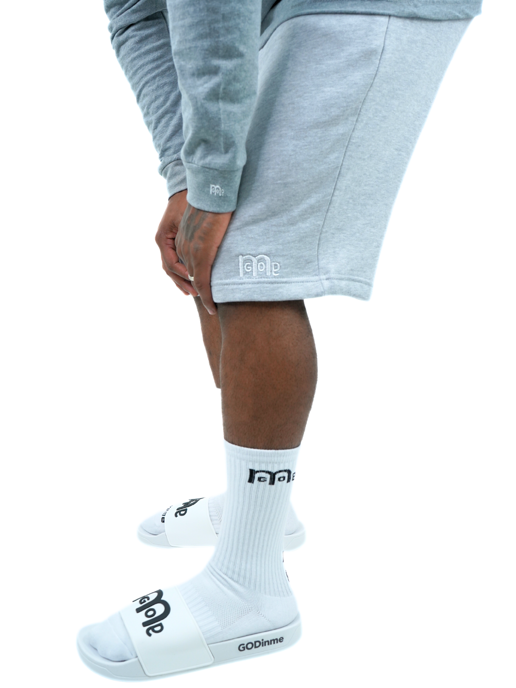 Perfect for any occasion, these Grey GODinme shorts provide an actively casual fit, jersey lined side and back pockets, elastic waistband, sewn eyelets, and fly details: providing the ultimate pair of shorts for any man of faith. But the White GODinme logo at left leg is the tell all, combining faith with fashion.