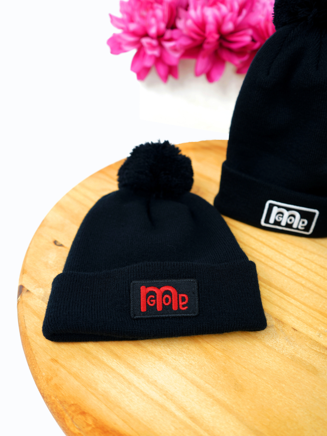 Black super soft silk like acrylic Pom Pom Beenie with Red iconic GODinme patch logo adding the perfect unique representation of GOD: in you.