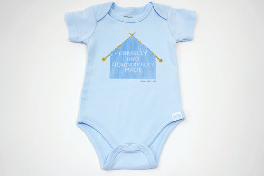 Blue Infant Onesie with "Fearfully and Wonderfully Made" printed on front and woven tag GODinme logo at left leg.