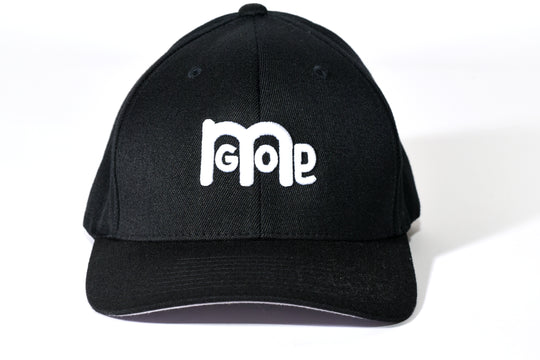 Smooth and sleek Black 6 panel Fitted Hat has curved Silver under visor with puff style GODinme logo embroidered in White on front and flat style GODinme name embroidered on back.