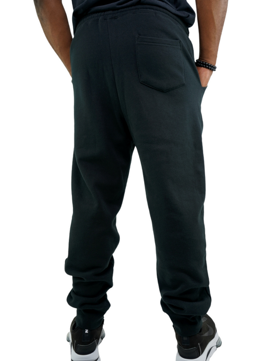 Experience the ultimate comfort in Men's joggers with GODinme! Made with premium quality fabric, these Black GODinme sweat pants offer an elastic waistband for that perfectly relaxed fit. Featuring ribbing ankle cuffs, sewn eyelets, and the signature GODinme logo at left leg.